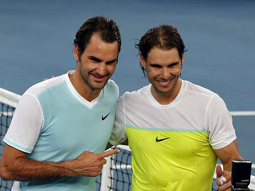 UAE Royals' Federer of Switzerland and Indian Aces' Nadal of Spain pose for pictures after their men's singles match in IPTL in New Delhi. Reuters