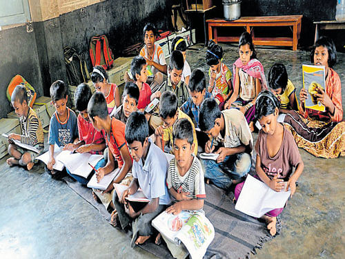Students at a government primary school are forced to sit on the floor due to lack of facilities. DH file photo