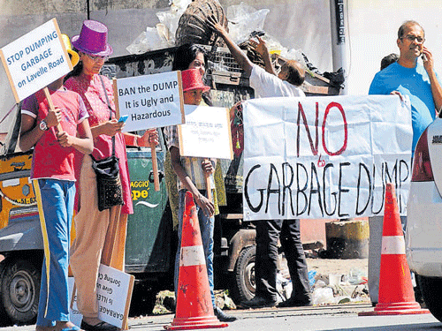 Residents of Lavelle Road protest unscientific disposal of garbage in their area.