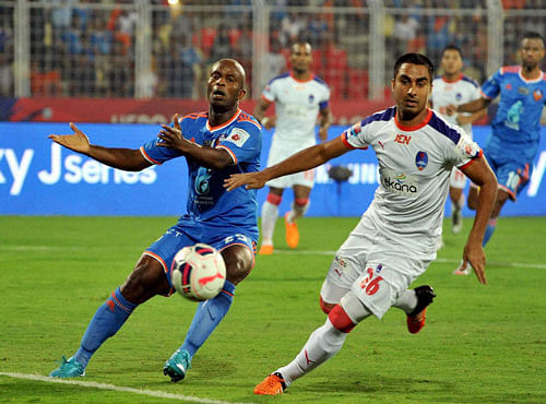 Players of FC Goa and Delhi Dynamos vie for the ball during the semifinal match in Fatorda, Goa on Tuesday. PTI Photo