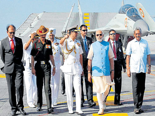 Prime Minister Narendra Modi flanked by Defence Minister Manohar Parrikar, Chief of Naval Staff  Admiral R K Dhowan and Chief of Army Staff General Dalbir Singh visit INS Vikramaditya, in Kochi on Tuesday. PTI