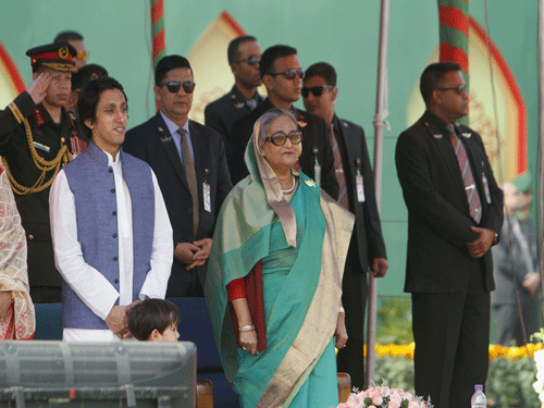 Hasina stands along with army officers for the national anthem during the celebration of the country's 45th Victory Day, at the national parade ground in Dhaka. Reuters Photo.