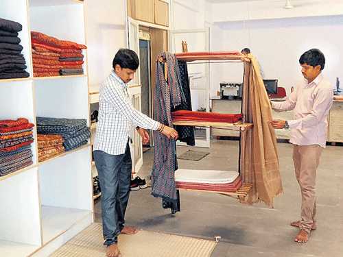 Salesmen display Malkha fabric in a showroom in Secunderabad. JBS Umanadh