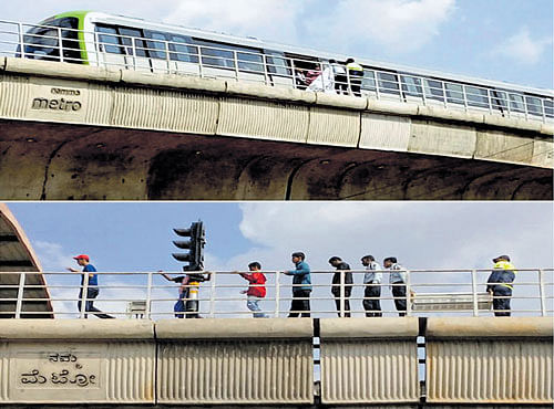 Metro staff evacuate passengers near Rajajinagar station in Bengaluru on Monday.