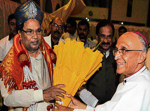 Season's greetings: Chief Minister Siddaramaiah is felicitated by Archbishop of Bengaluru Bernard Moras at the Christmas get-together organised by the Archdiocese of Bangalore at  St Germain's Institutions in the City on Tuesday. Bengaluru Development Minister K J George is also seen. DH Photo