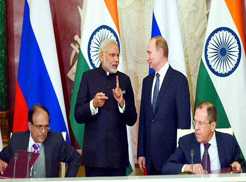 Prime Minister Narendra Modi talks with Russian President Vladimir Putin during signing of MOU at Kremlin Moscow on Thursday. PTI Photo