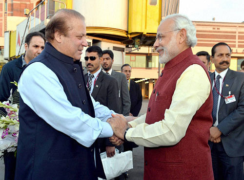 Prime Minister Narendra Modi is greeted by his Pakistani counterpart Nawaz Sharif on his arrival in Lahore on Friday. PTI Photo