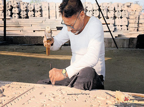 An artist carves stones at Karsevakpuramin Ayodhya. PTI