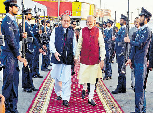 Prime Minister Narendra Modi is received by his Pakistani counterpart Nawaz Sharif upon his arrival in Lahore on Friday. PTI
