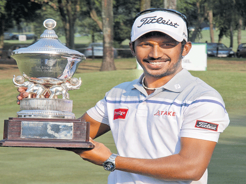 celebration time S Chikkarangappa holds aloft the McLeod Russel Tour golf championship title in Kolkata on Sunday.