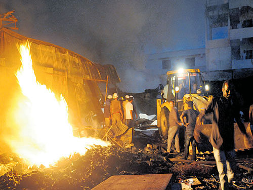 Fire fighters try to put out the inflames that gutted a furniture godownat Garvebhavipalya in the City on Tuesday. DH PHOTO