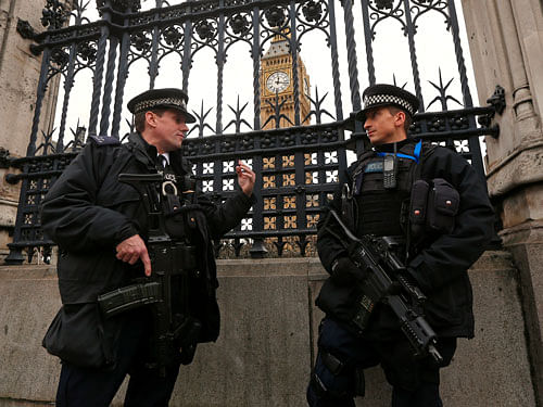 Armed police stand on duty outside The Houses of Parliament in London, reuters photo