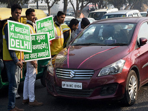 Volunteers with traffic police explaining the rules to an even number car owner near the Nizamuddin Bridge as Odd-even scheme restricting movement of private cars, becomes operational in New Delhi on Friday. PTI photo