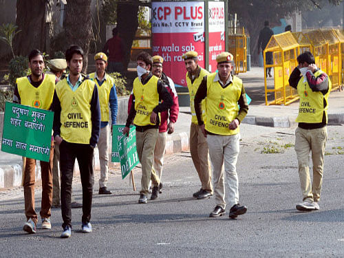 Civil Defence volunteers holding placards at ITO as Odd-even scheme restricting movement of private cars, is operational in New Delhi on Saturday. PTI photo