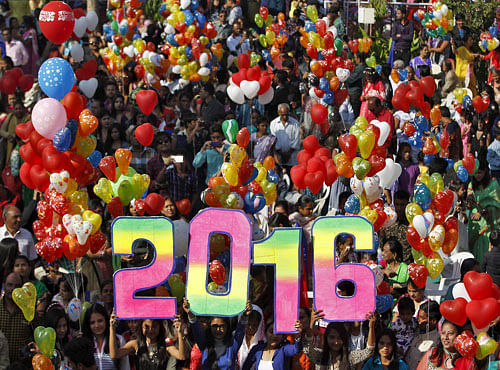 People hold balloons during the New Year celebrations. PTI photo