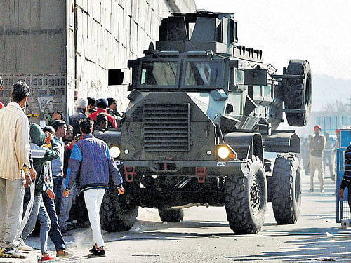 An armoured vehicle moves near the Pathankot Air Force base in Punjab which came under terror  attack on Saturday. PTI