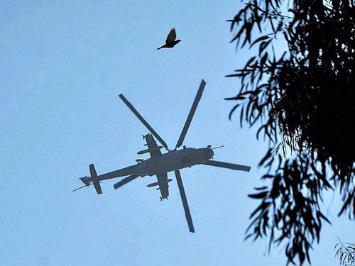 A chopper hovers over the Indian Air Force base that was attacked by militants in Pathankot. PTI Photo