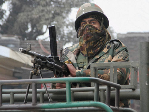 An army person guards during the operation against the militants at the Indian Air Force base in Pathankot on Monday. PTI Photo
