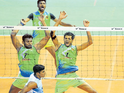Karnataka's Anup D'Costa (left) and A Karthik successfully block a smash by Services' Anshad  during their tie in Bengaluru on Monday. DH photo/ Srikanta Sharma R