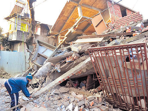 Damaged buildings in Manipur's capital Imphal on Monday. Photo: Deepak Oinam