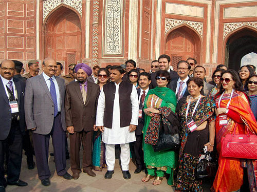 Uttar Pradesh Chief Minister Akhilesh Yadav in a group photograph with Indian diaspora at the Taj Mahal during celebration of Uttar Pradesh Pravasi Diwas in Agra on Tuesday. PTI Photo