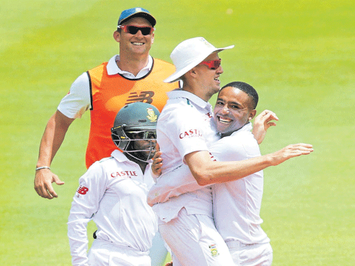 infusing life: South Africa's Dane Piedt (right) celebrates with team-mates after dismissing England's Ben Stokes in the second Test on Wednesday. REUTERS