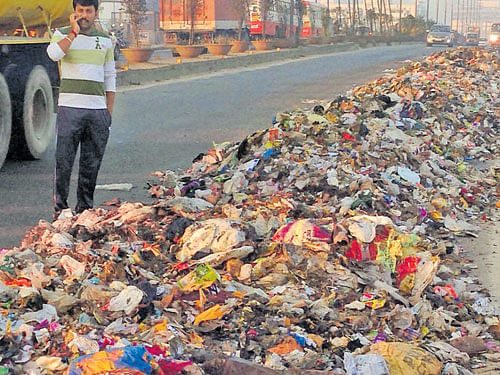what a sight: Garbage dumped on the KR Puram flyover  in the City on Wednesday morning. dh Photo