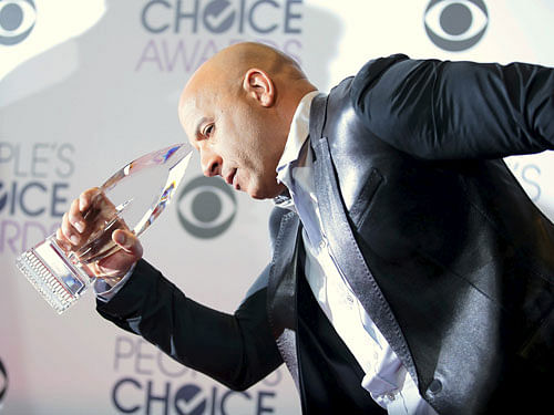 Actor Vin Diesel poses backstage with the awards for Favorite Movie and Favorite Action Movie for 'Furious 7' during the People's Choice Awards 2016 in Los Angeles, California January 6, 2016. REUTERS