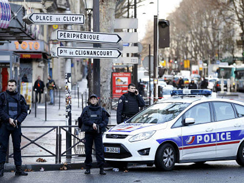 French police secure the area after a man was shot dead at a police station in the 18th district in Paris. REUTERS