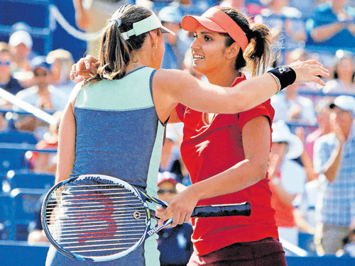 Sania Mirza and her Swiss partner Martina Hingis, pti file photo