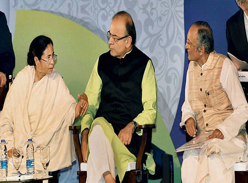 Finance Minister Arun Jaitley, West Bengal Chief Minister Mamata Banerjee and State Finance Minister Amit Mitra during Bengal Global Business Summit in Kolkata on Friday. PTI Photo.
