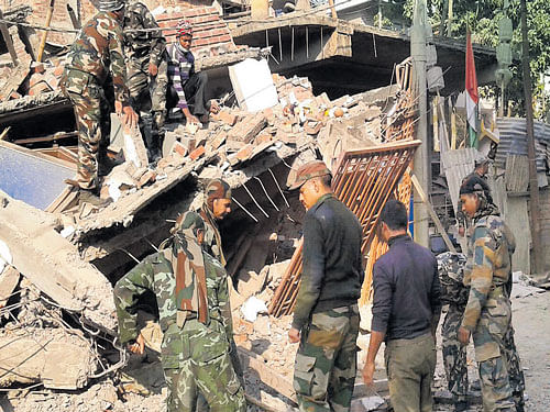The Assam Rifles personnel search for survivors after a massive quake struck Imphal on Monday. photo deepak oinam