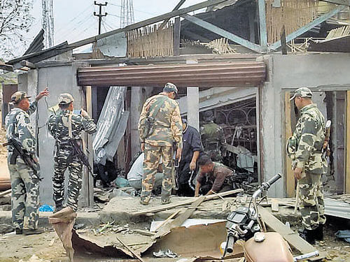 Army personnel inspect damage at the blast site. SAIDUL KHAN