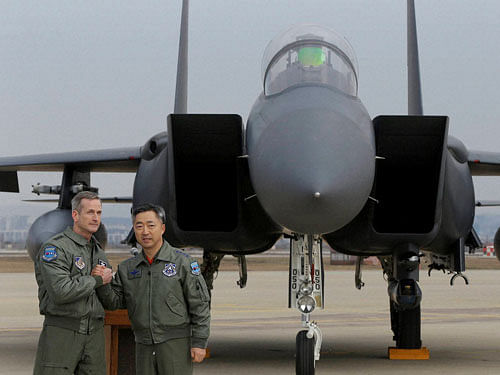 Lt. Gen. Terrence O'Shaughnessy, left, 7th Air Force commander of the U.S. Forces to Korea, and South Korean Air Forces Commander Lee Wang-geun pose in front of a South Korean F-15K fighter jet after a press briefing on the flight by a U.S. Air Force B-52 bomber over South Korea at the Osan Air Base in Pyeongtaek, South Korea, Sunday, Jan. 10, 2016. PTI/AP photo