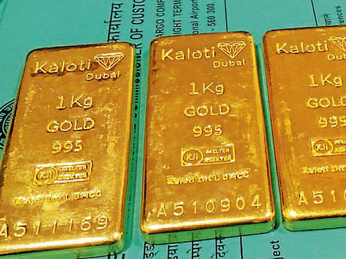 Customs officials recover four gold bars each weighing 1 kg froma passenger at KIA on Thursday. DH PHOTO