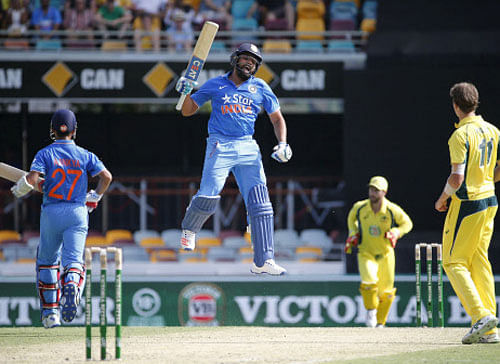 Rohit Sharma (C) jumps as he celebrates reaching his century during the second One Day International cricket match against Australia. Reuters