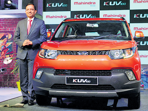 M&M Executive Director Pawan Goenka unveils the KUV100 at the company's plant in Chakan on Friday.