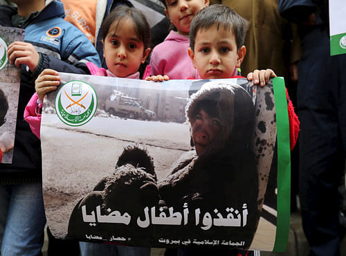 Children hold a poster during a sit-in organised by the Sunni Al Jama'a al-Islamiya group, calling for the lifting of the siege off Madaya, in front of the ICRC in Beirut. Reuters file photo
