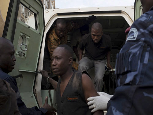 People who escaped from the Cappuccino restaurant exit a Burkina Faso military vehicle in Ouagadougou, Burkina Faso. Two Indians were among 126 people freed from the restaurant that was under siege by al Qaeda linked gunmen who killed at least 23 people. Reuters photo