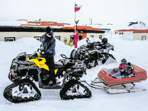 a freezing ride: Children are collected by a parent from school in the town of Villa Las Estrellas, on the Chilean President Eduardo Frei Montalva Base, in Antarctica. The tiny hamlet has been at the centre of one of Antarctica's most remarkable experiments: exposing entire families to isolation and extreme conditions in an attempt to arrive at a semblance of normal life at the bottom of the planet. nyt