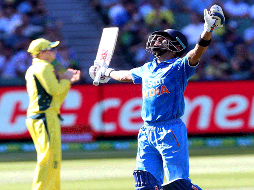 India's Virat Kohli celebrates his century as Australia's Steven Smith applauds during their One Day cricket match at the Melbourne Cricket Ground. Reuters Photo.