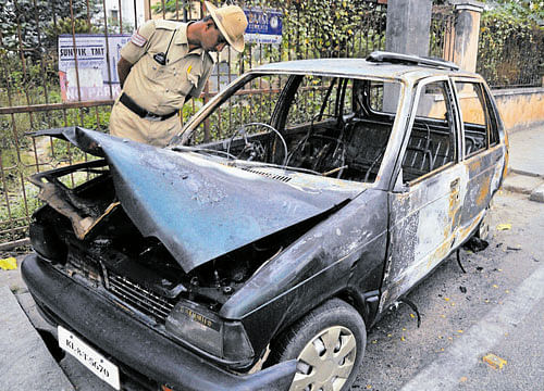 The remains of the car which caught fire near Cauvery  Junction on Saturday. DH PHOTO