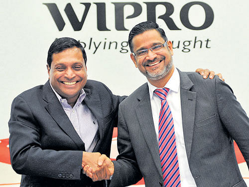 Wipro CEO T K Kurien (left) shares a light moment with  CEO-designate Abidali Z Neemuchwala at the company's Q3  results in Bengaluru on Monday. DH Photo BY Srikanta Sharma R