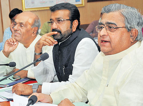 K&#8200;B&#8200;Koliwad, chairman of the House Committee on Lake  Encroachments (right), speaks at a review meeting in the City on Monday. (From left) Committee members B R Yavagal and N A Haris are seen. dh photo