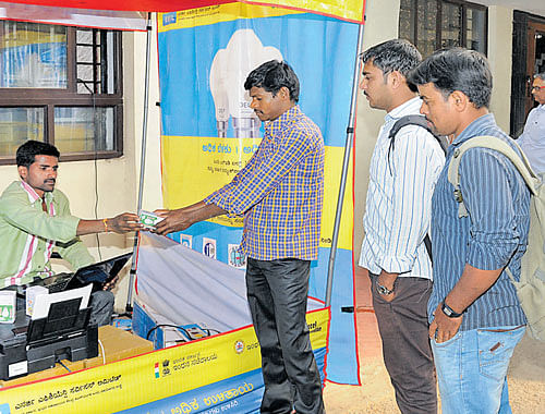 People purchase LED bulbs at subsidised prices under the Domestic Efficient Lighting Programme (DELP) at the Bescom office at KR Circle in Bengaluru. dh file photo