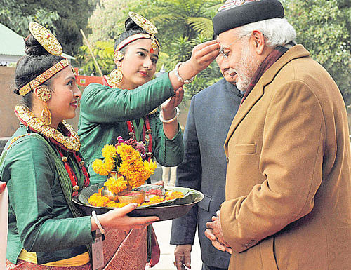 Prime Minister Narendra Modi being given a traditional welcome on his  arrival  in Gangtok on Monday. PTI