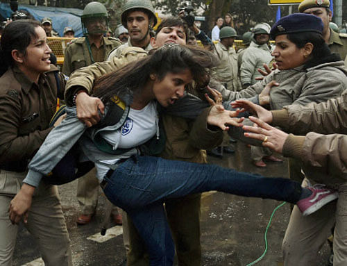 Police detain a girl student during a protest against the Ministry of Human Resource Development in New Delhi on Monday over the suicide of a PhD scholar Rohith Vemula at University of Hyderabad. PTI Photo