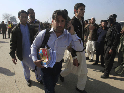 A student holding his books talks on a mobile phone, after he was rescued in a militant attack at Bacha Khan University in Charsadda, Pakistan. Reuters Photo.