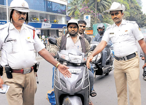 With the grace period for rule making helmets mandatory for pillion riders ending on Tuesday, traffic police inspectors started slapping fines on violators fromWednesday. DH