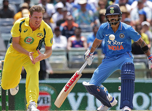Australia's James Faulkner fields the ball as India's Virat Kohli looks on during the One Day International cricket match in Perth. Reuters photo